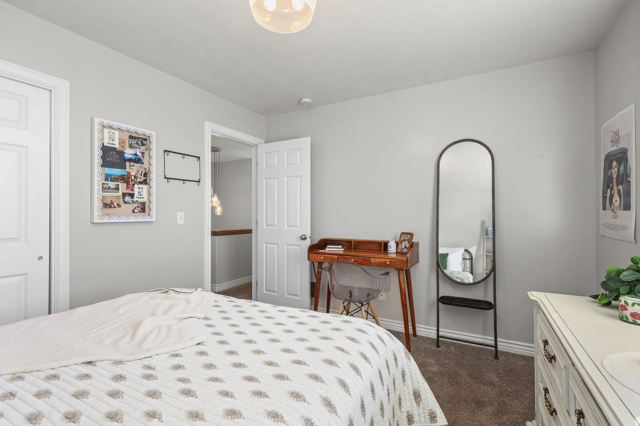 Bedroom with baseboards and dark carpet