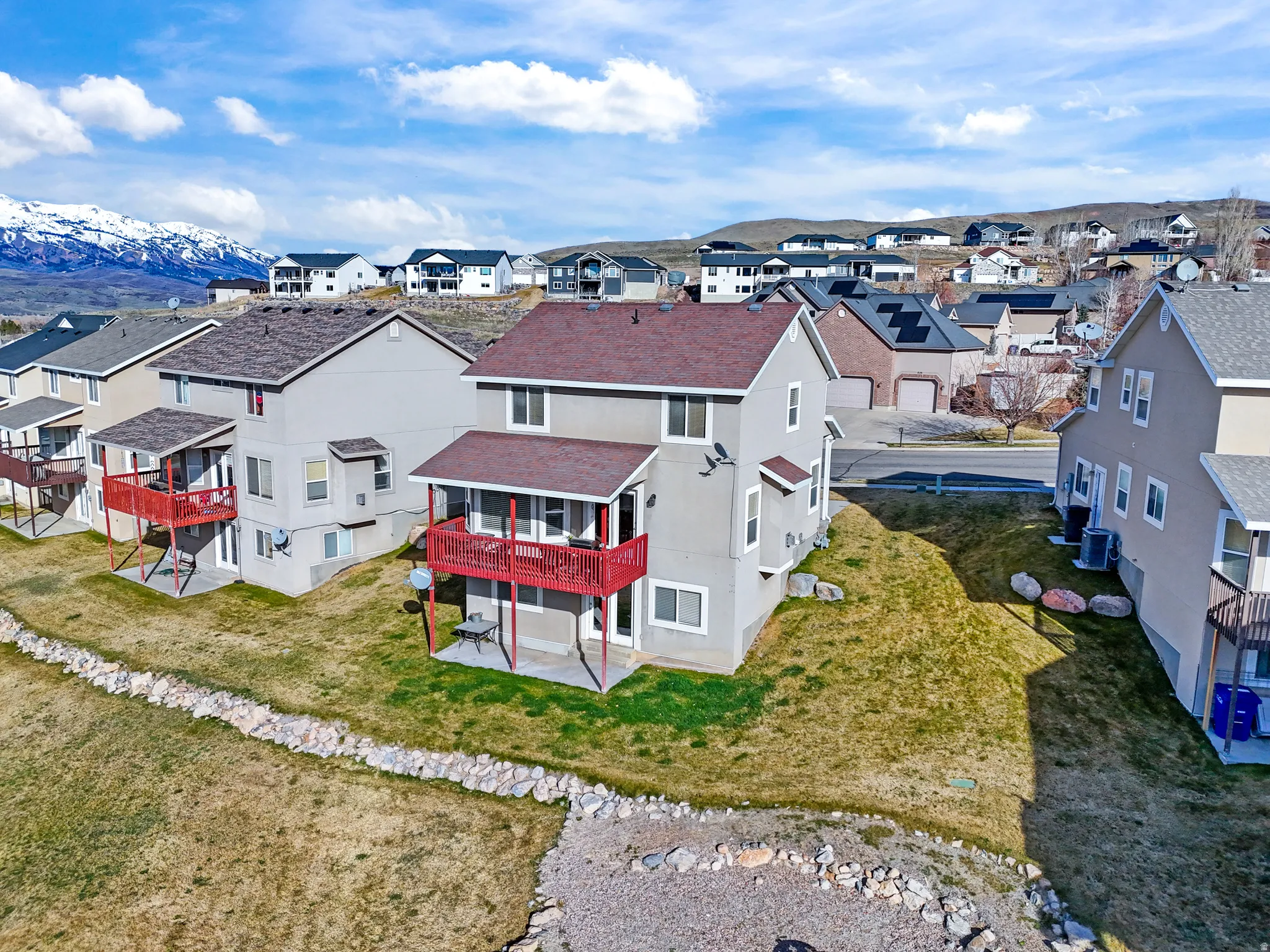 Aerial perspective of suburban area with a mountainous background