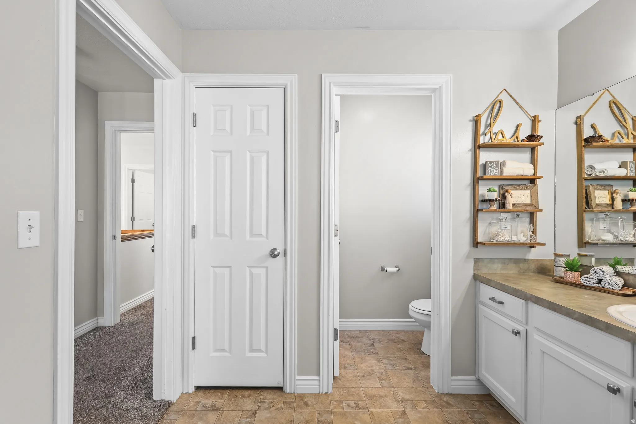 Bathroom featuring vanity and stone finish floors