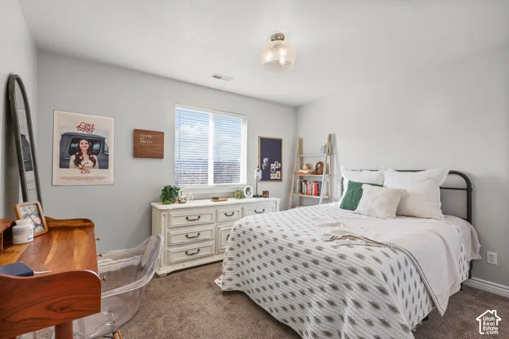 Bedroom with dark colored carpet