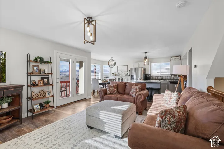 Living room featuring dark wood-style floors and a chandelier