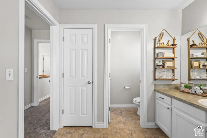 Bathroom featuring vanity and stone finish floors