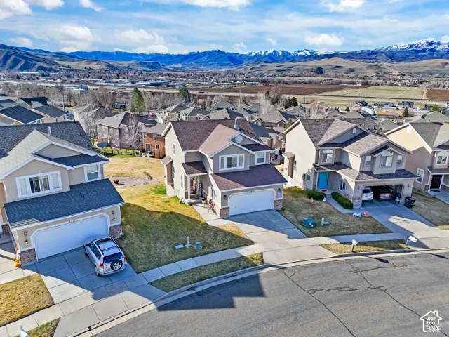 Aerial perspective of suburban area featuring a mountainous background