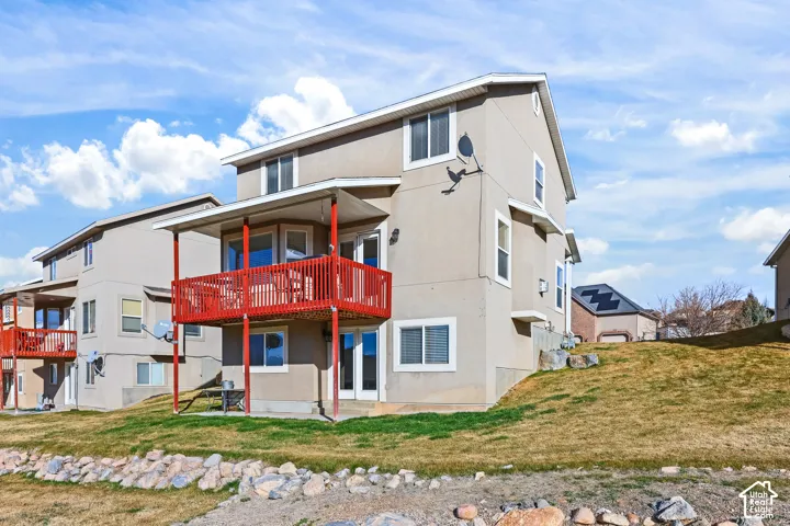 View of front of property with a patio area, a front yard, and stucco siding