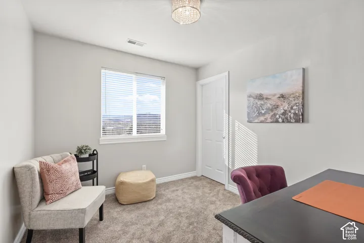 Home office featuring carpet floors and hanging lights