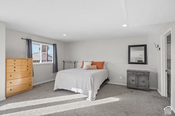 Bedroom with light carpet and recessed lighting