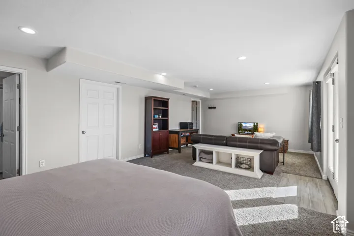 Carpeted bedroom with recessed lighting and baseboards