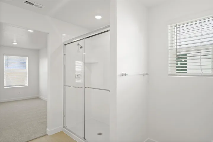 *DISCLAIMER* Interior package and colors may vary.  Full bath featuring a shower stall, light wood-type flooring, and recessed lighting