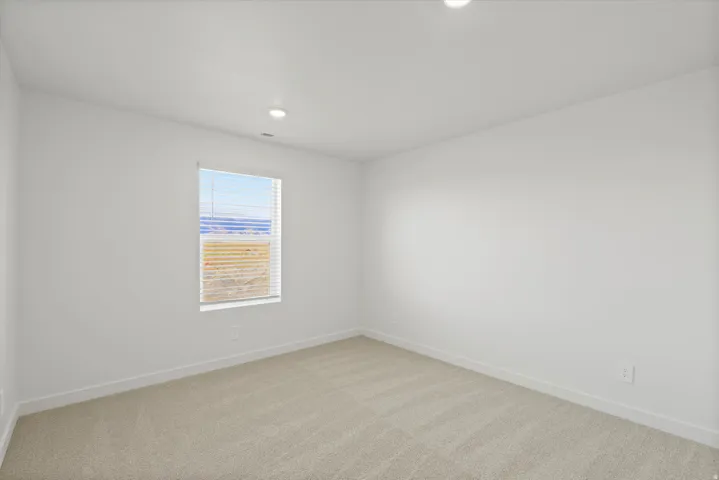 *DISCLAIMER* Interior package and colors may vary.  Empty room featuring light colored carpet and recessed lighting