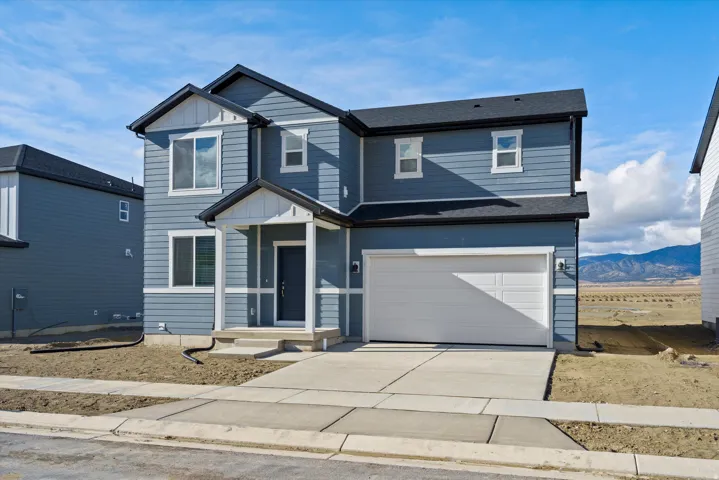 **DISCLAIMER** Exterior elevation and color may vary. View of front of property featuring a garage, concrete driveway, board and batten siding, roof with shingles, and a mountain view
