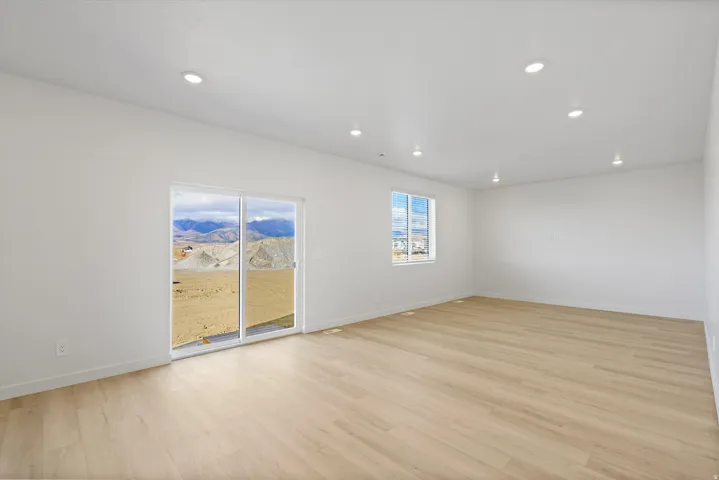 *DISCLAIMER* Interior package and colors may vary.  Empty room featuring light wood-type flooring and recessed lighting