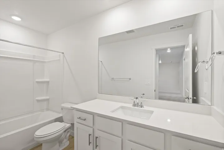 *DISCLAIMER* Interior package and colors may vary.  Bathroom featuring vanity, bathtub / shower combination, and recessed lighting