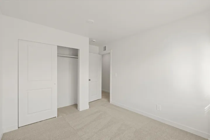 *DISCLAIMER* Interior package and colors may vary.  Unfurnished bedroom featuring light carpet and a closet