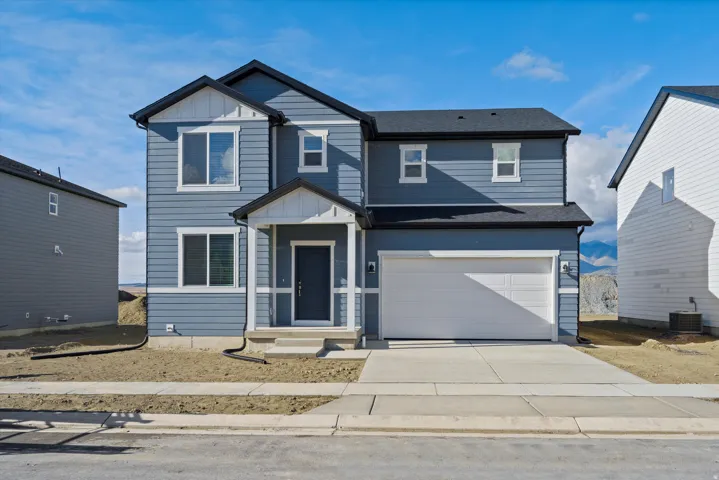 **DISCLAIMER** Exterior elevation and color may vary. View of front of property featuring board and batten siding, driveway, a garage, and a shingled roof