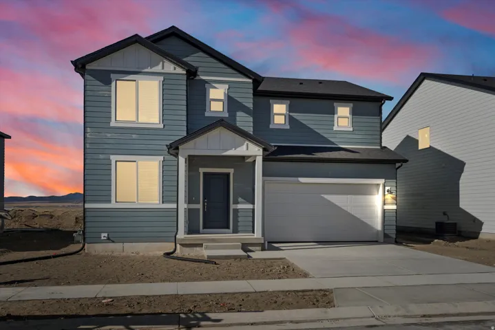 **DISCLAIMER** Exterior elevation and color may vary. View of front of property featuring concrete driveway, board and batten siding, an attached garage, and roof with shingles