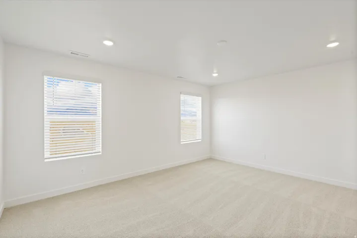 *DISCLAIMER* Interior package and colors may vary.  Empty room featuring light colored carpet and recessed lighting