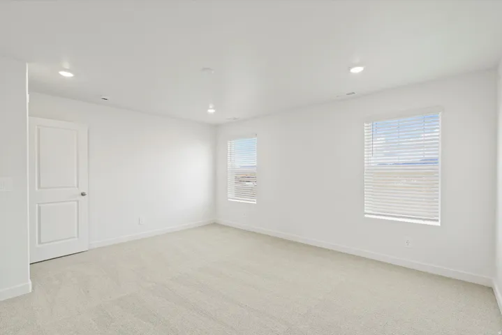 *DISCLAIMER* Interior package and colors may vary.  Empty room featuring light colored carpet, plenty of natural light, and recessed lighting
