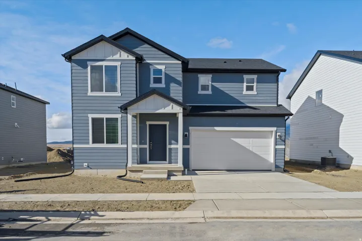 **DISCLAIMER** Exterior elevation and color may vary. View of front of house featuring driveway, board and batten siding, and an attached garage