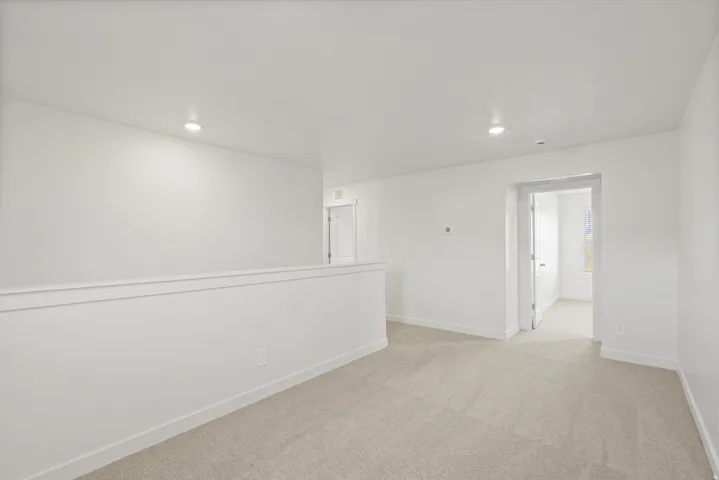 *DISCLAIMER* Interior package and colors may vary.  Empty room featuring light carpet and recessed lighting