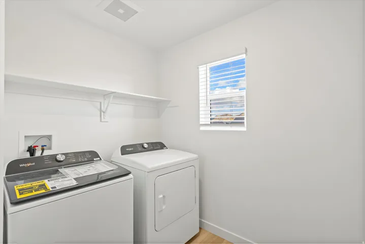 *DISCLAIMER* Interior package and colors may vary.  Laundry room featuring independent washer and dryer and light wood-type flooring