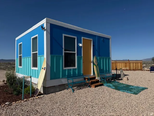 View of front facade featuring entry steps, board and batten siding, and a mountain view