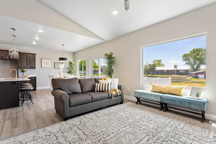 Living room featuring recessed lighting, light wood-type flooring, vaulted ceiling, and a ceiling fan