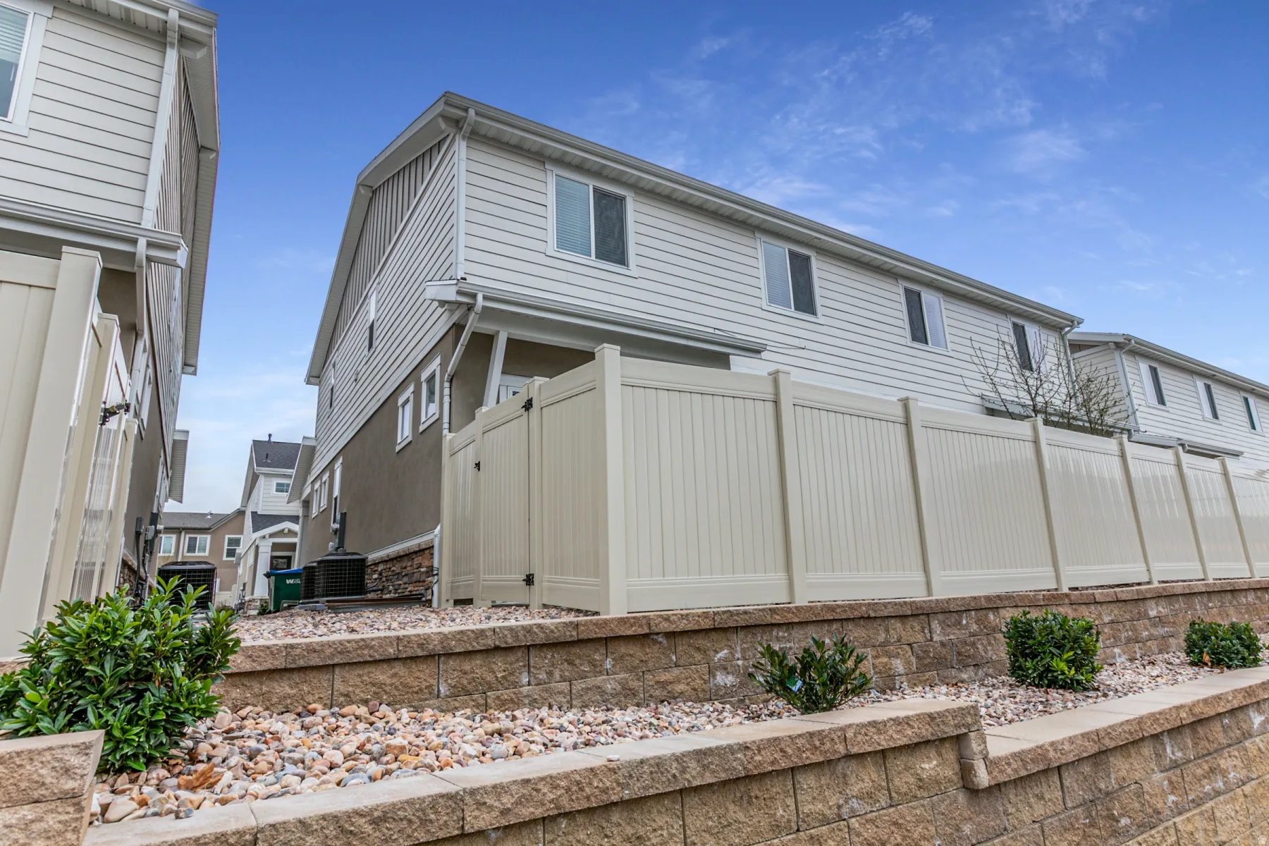 View of side of home featuring a cooling unit