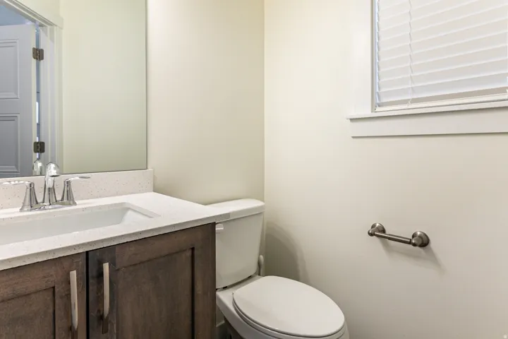 Half bath featuring vanity and toilet