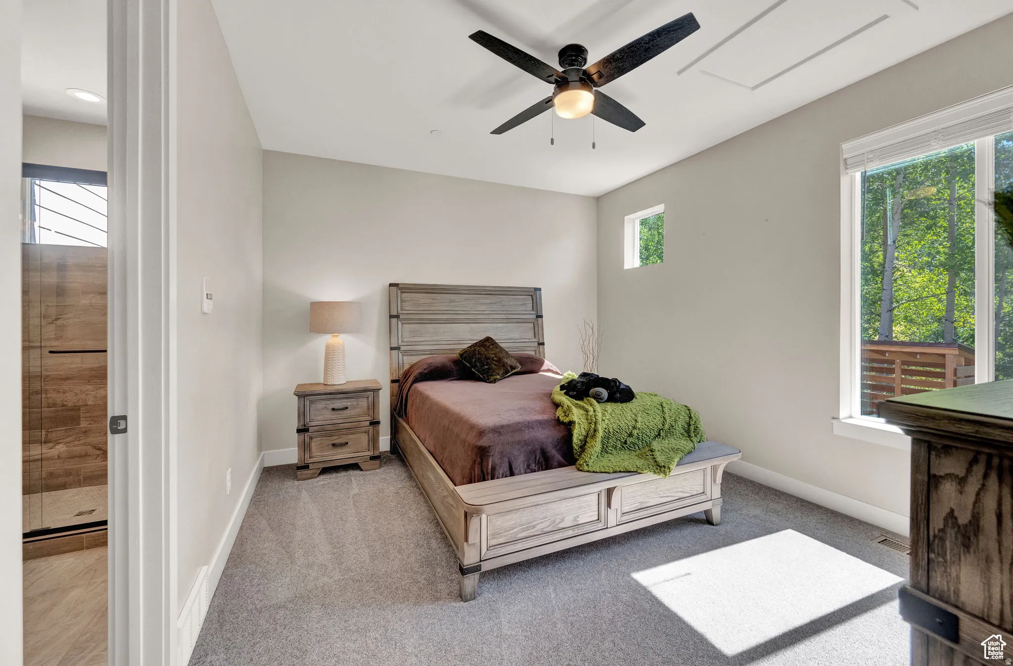 Bedroom featuring carpet floors, multiple windows, and ceiling fan