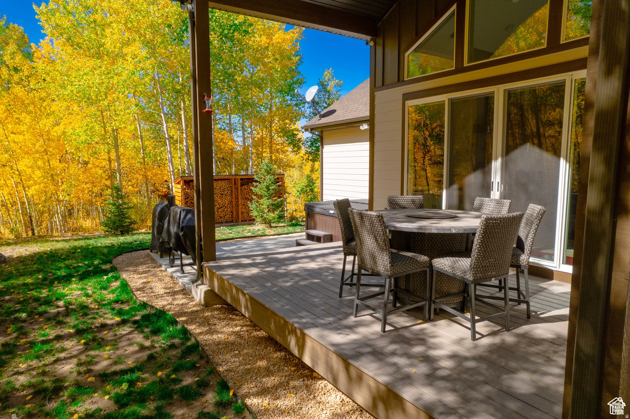 View of patio with outdoor dining space and a hot tub