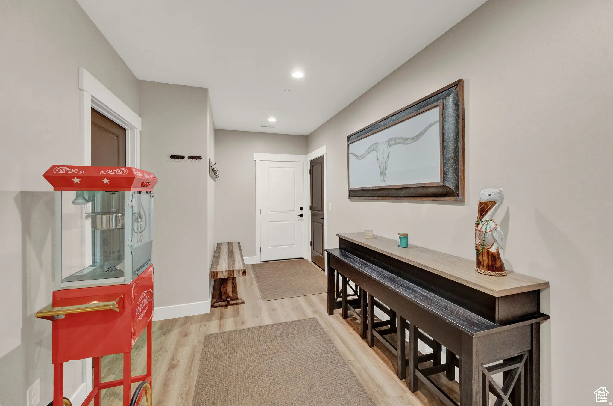 Corridor featuring light wood finished floors and recessed lighting