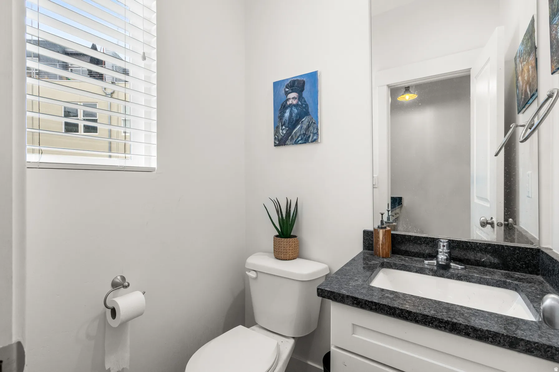 Half bathroom featuring toilet and vanity