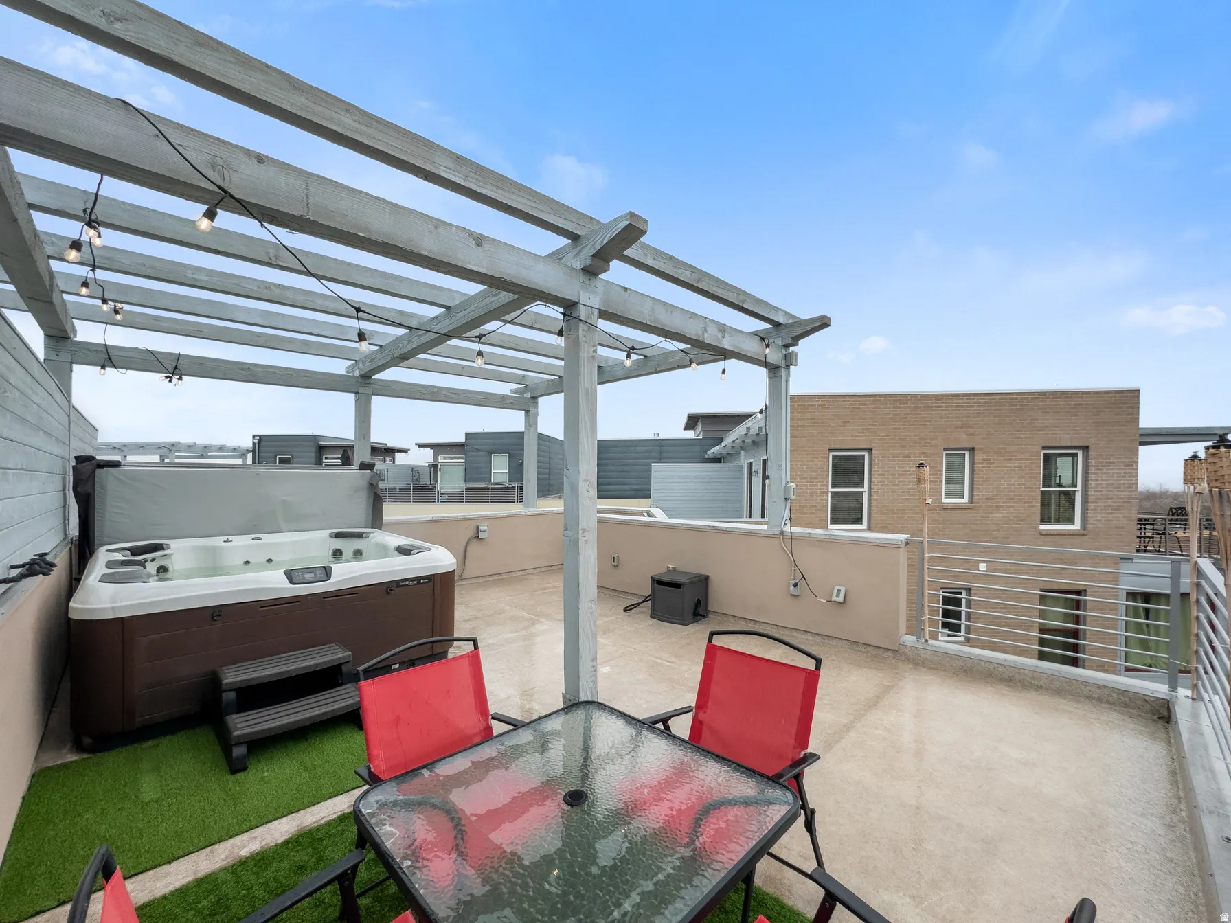 View of patio with a hot tub and outdoor dining space