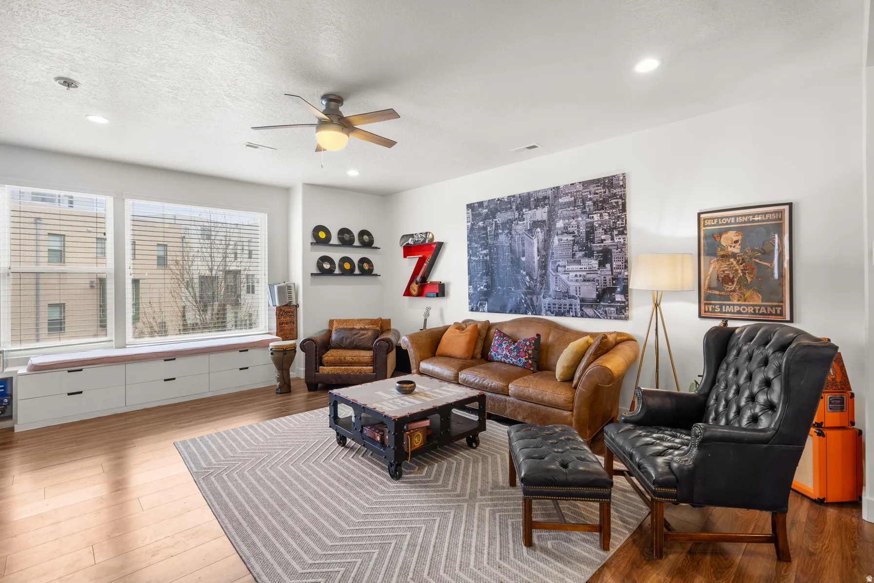 Living area with a ceiling fan, wood-type flooring, a textured ceiling, and recessed lighting