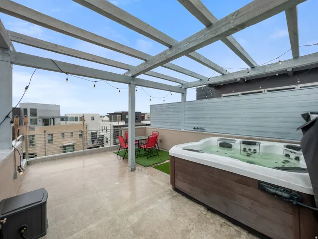 View of patio with a hot tub