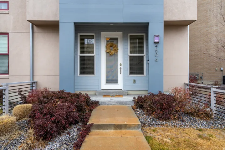 Property entrance with stucco siding and a porch