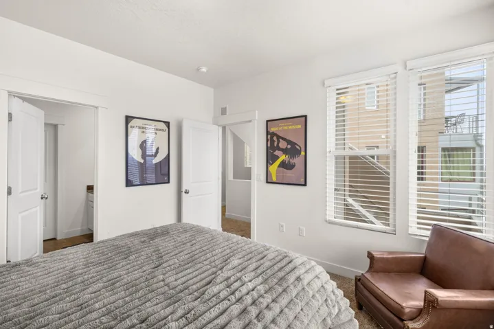 Bedroom with dark carpet and a textured ceiling