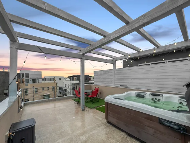 Patio terrace at dusk with a patio area and a hot tub