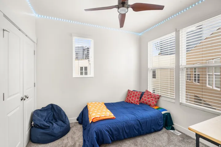 Bedroom with carpet flooring, a ceiling fan, and a closet