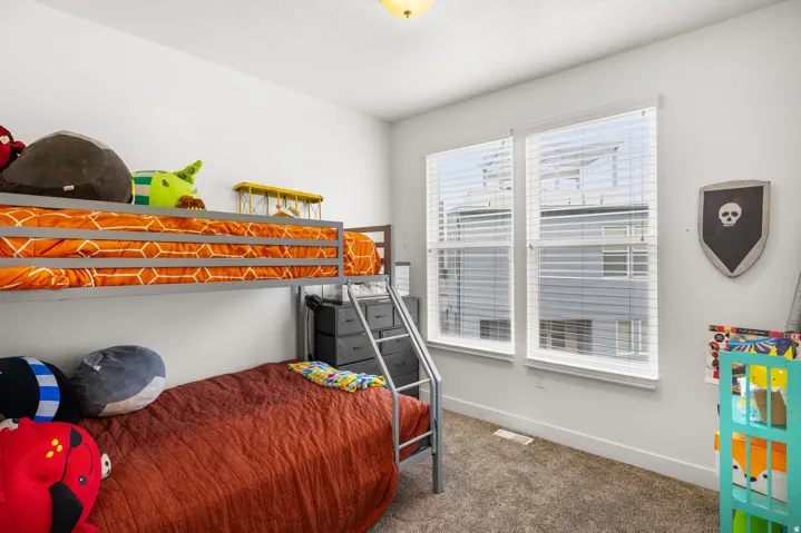 Bedroom featuring carpet flooring and baseboards