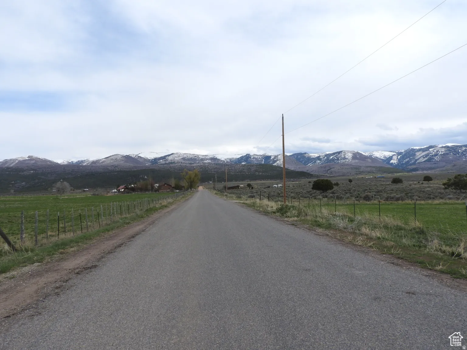 View of asphalt road with a mountain view and a rural view