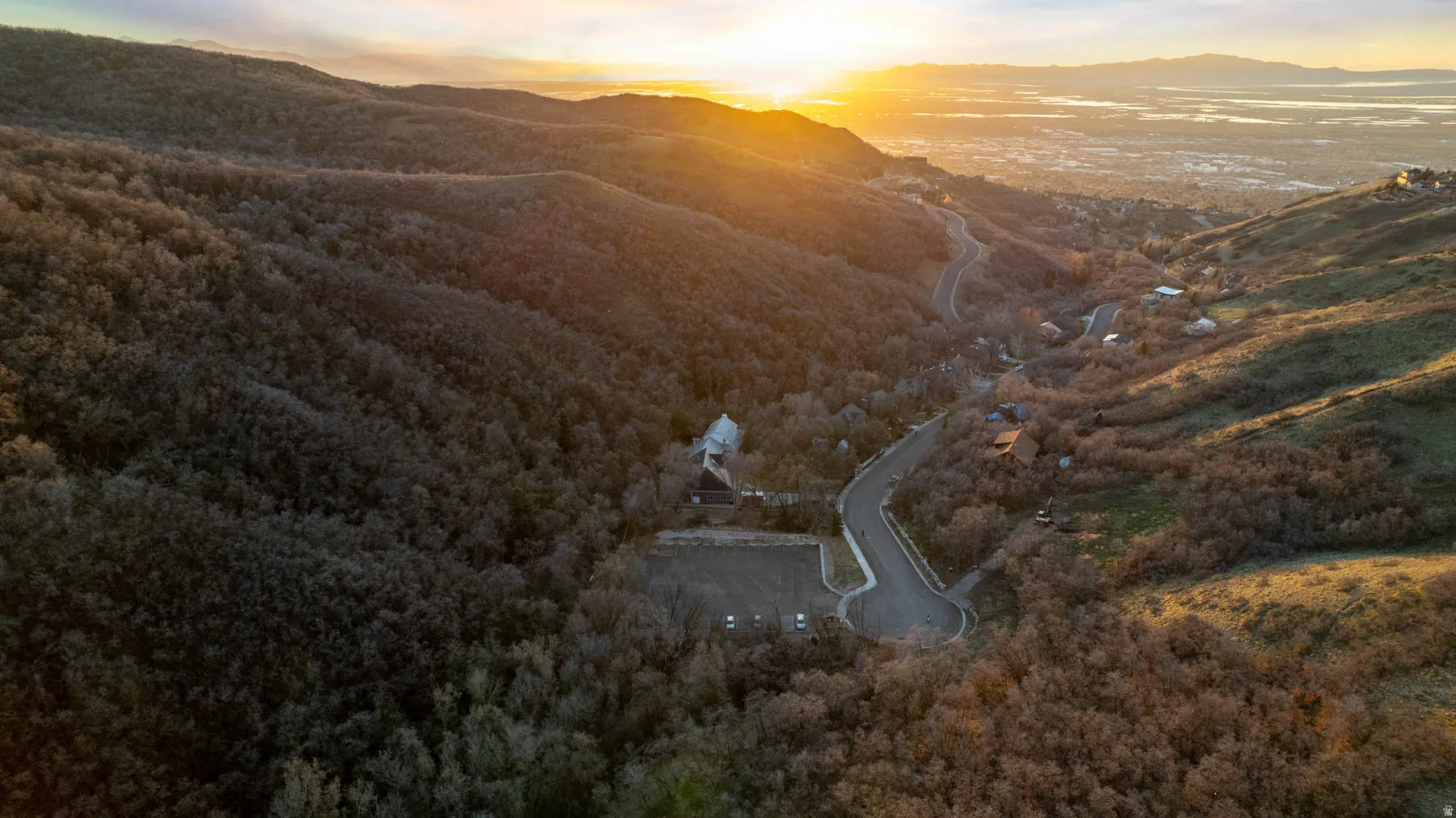 Aerial view at dusk of a mountain view and a wooded view