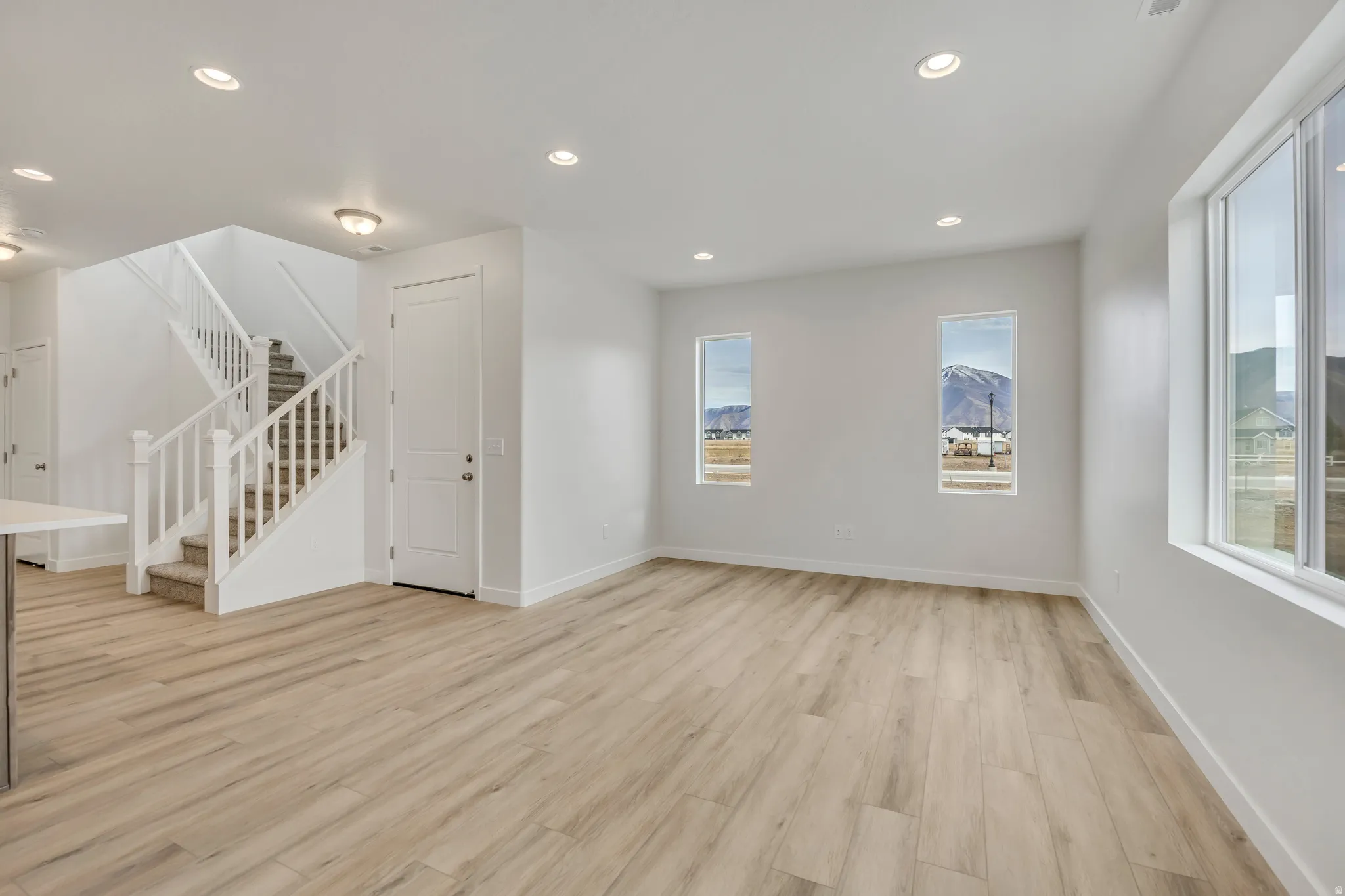 Unfurnished living room with recessed lighting and light wood-type flooring