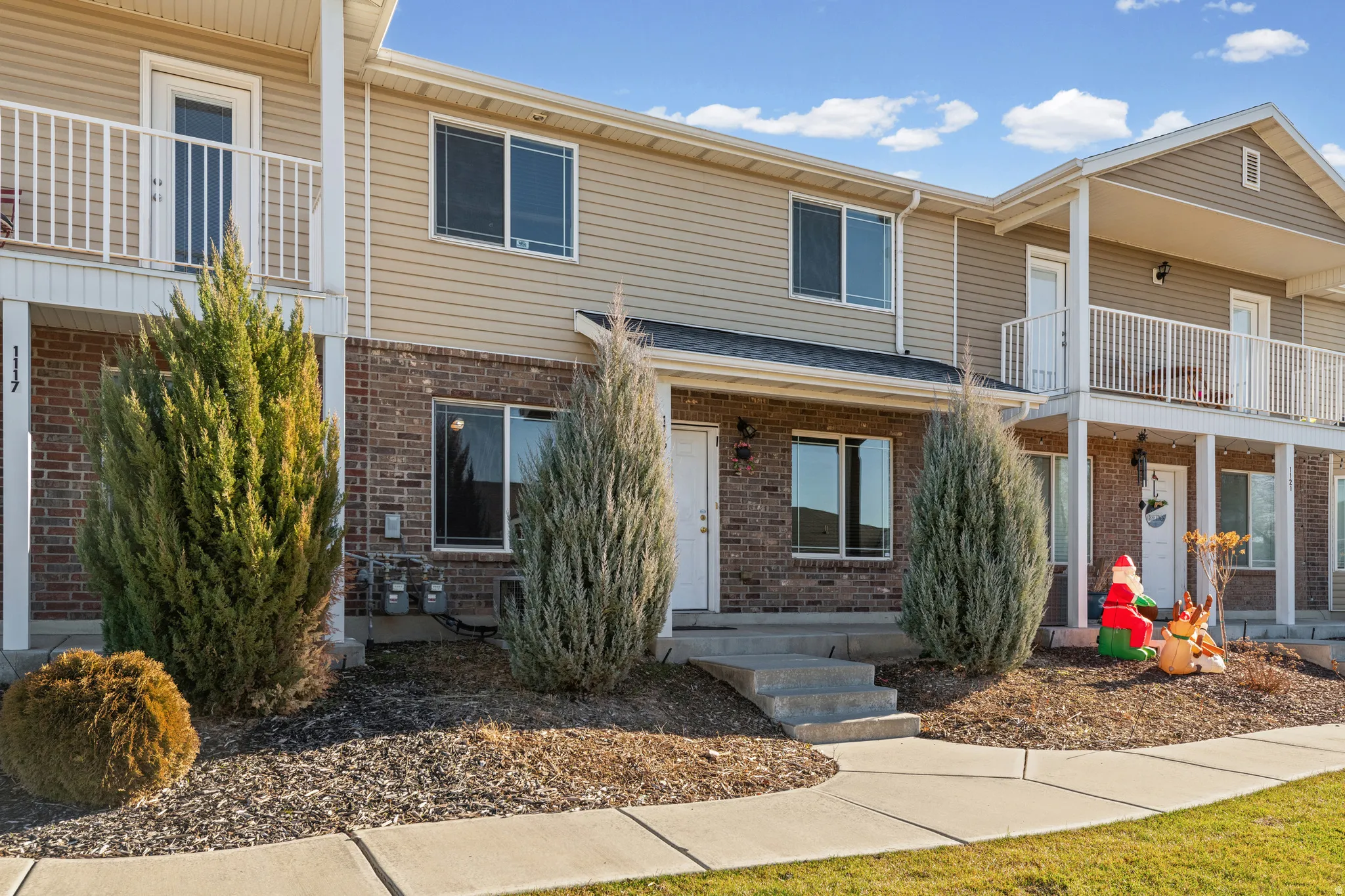 Traditional-style home with a balcony and brick siding