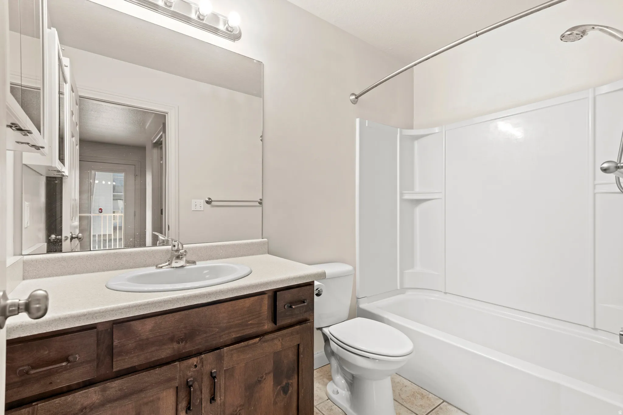 Full bathroom featuring vanity, shower / bathtub combination, and light tile patterned floors