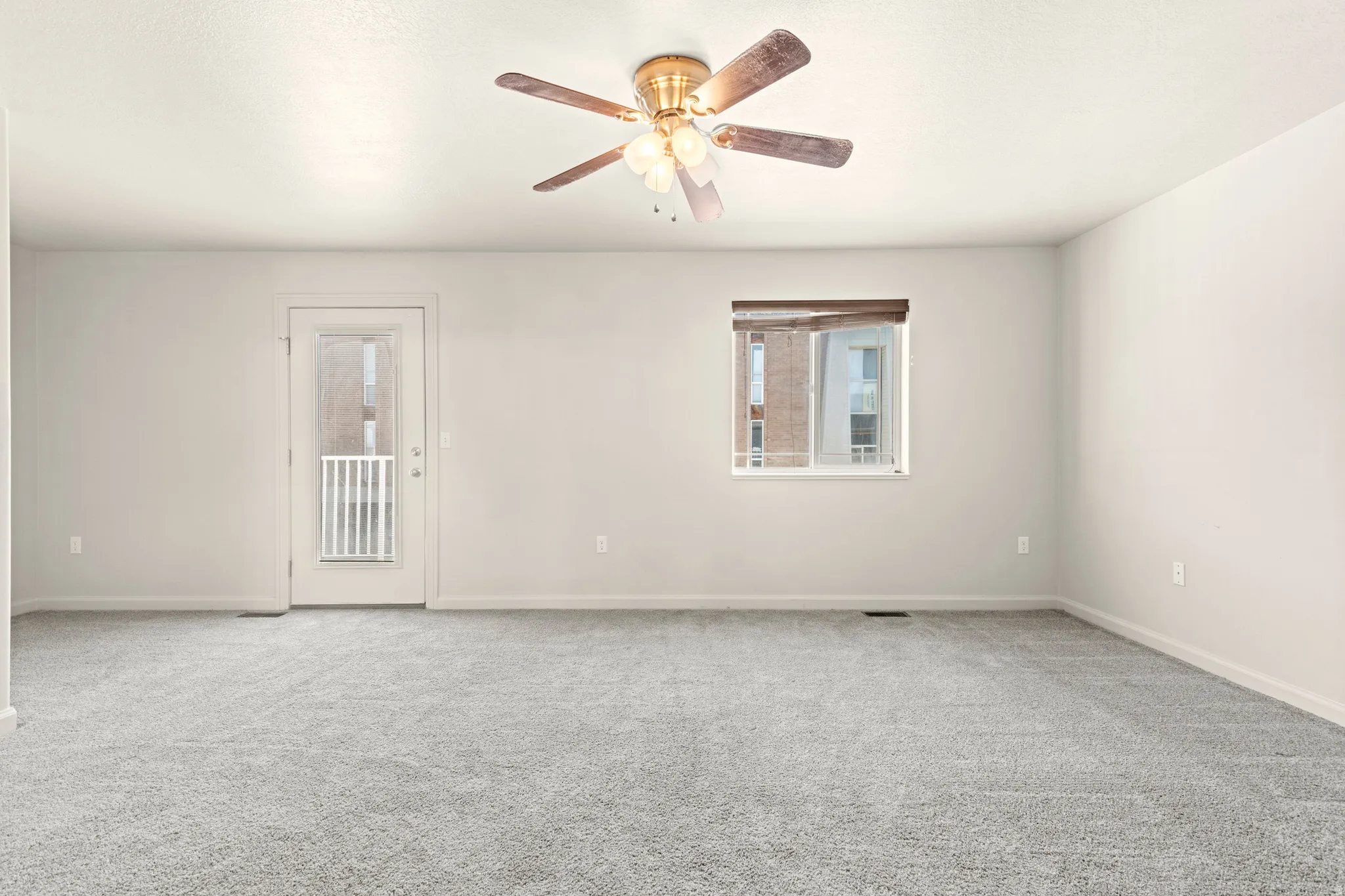 Unfurnished room featuring ceiling fan and carpet