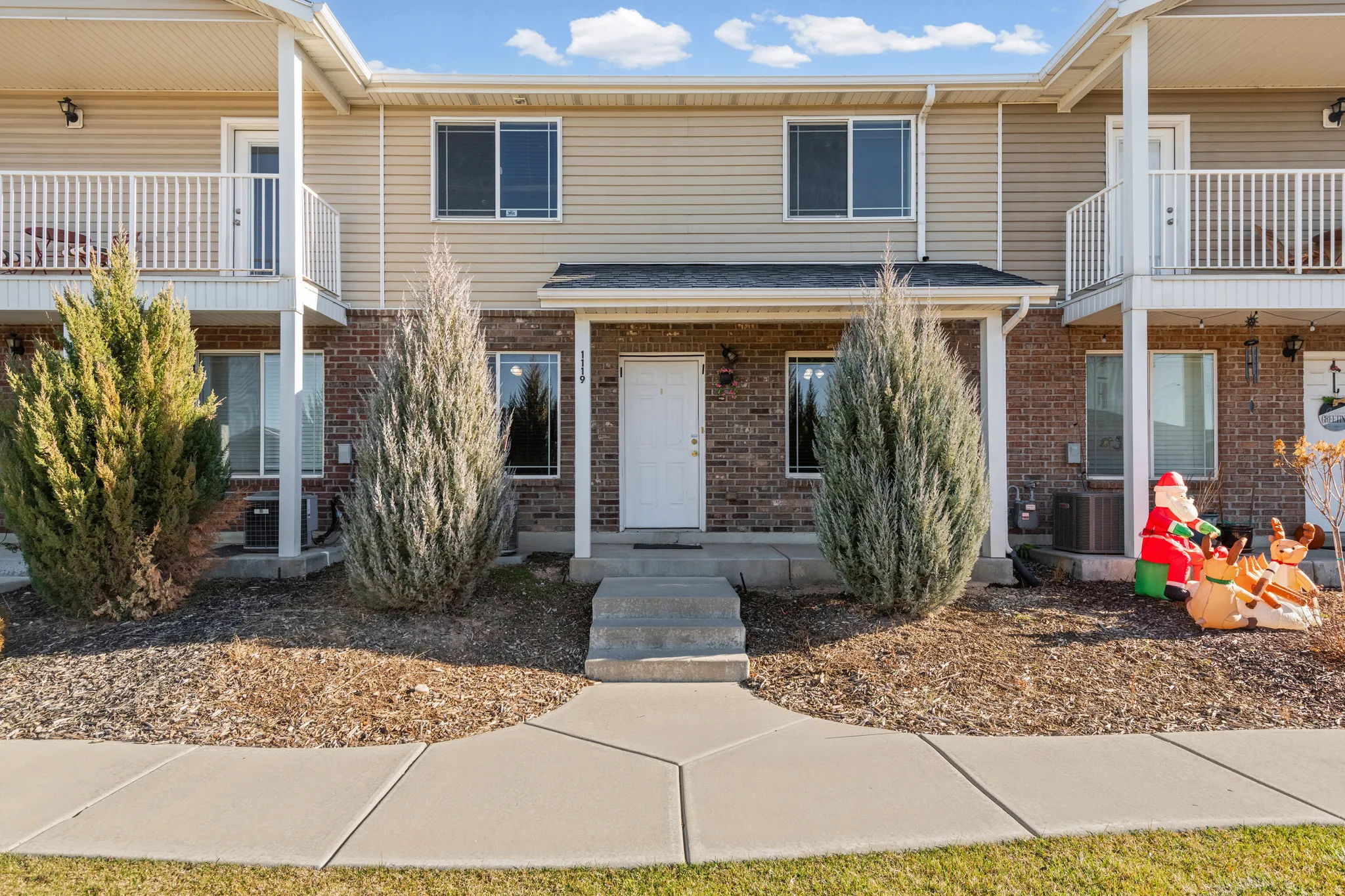 Traditional home with a balcony and brick siding
