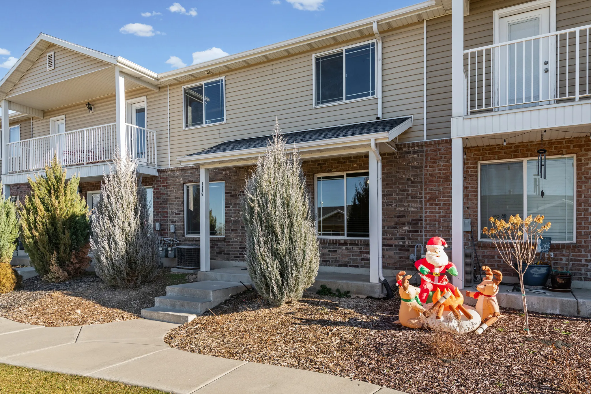 Traditional home featuring a balcony and brick siding