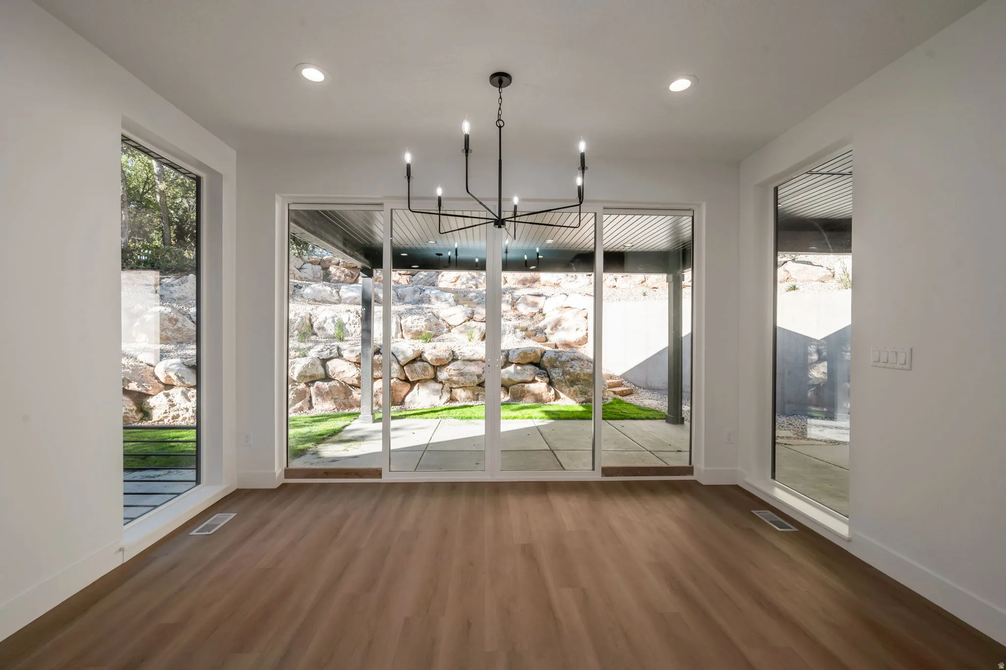 Unfurnished dining area featuring a chandelier and dark wood-style floors
