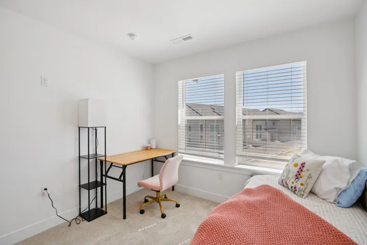 Office area featuring light carpet and baseboards